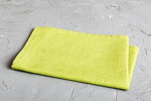 top view with green kitchen napkin isolated on table background. Folded cloth with copy space photo