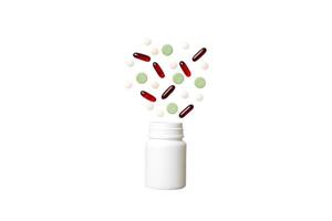 Multicolored pills and capsules plastic bottle on Colored background. Many different various medicine tablets and pills, vitamin and nutritional supplements concept photo