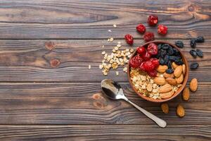 Cooking a wholesome breakfast. Granola with Various dried fruits and nuts in a bowl. The concept of a healthy dessert. top view with copy space photo