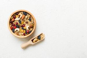 Cooking wholesome breakfast. Granola with Various dried fruits and nuts in a bowl. The concept of a healthy dessert. top view with copy space photo