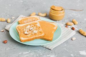 Peanut butter sandwiches toasts light table background.Breakfast. American cuisine photo