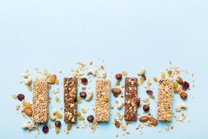 granola bars on table background. Cereal granola bars. Superfood breakfast bars with oats, nuts and berries photo
