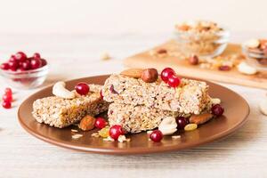 Various granola bars on table background. Cereal granola bars. Superfood breakfast bars with oats, nuts and berries . Superfood concept photo