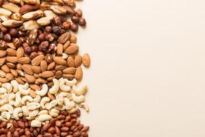 different nuts frame background. flat lay with vopy space. pistachios, hazelnuts and cashews photo
