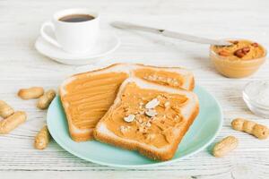 Peanut butter sandwiches toasts light table background.Breakfast. American cuisine top view photo