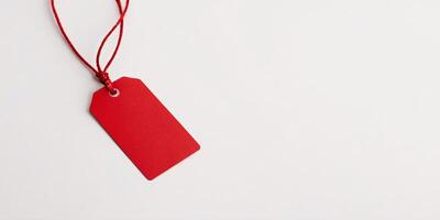 Red tag with string on white background. photo