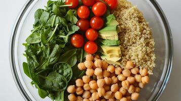 This Fresh ingredients like spinach, quinoa, and cherry tomatoes create a nutritious meal option. photo