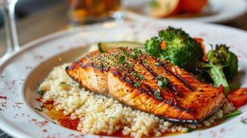 This Grilled salmon atop couscous paired with vibrant vegetables highlights healthy eating choices. photo