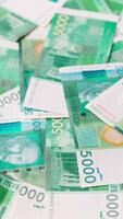 rotating background of 5000 Kyrgyzstani Som banknotes, closeup full-frame loopable background video