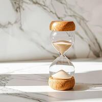 an hourglass on a marble background photo
