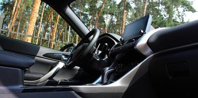 Panoramic photo of the interior of the car with a view of the green hedge of the park in the windows