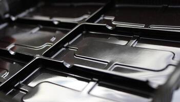 Separate Rectangular Slots On A Dark Varnished Plastic Panel photo