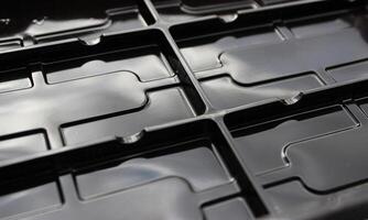 Abstract background of black figured extruded elements photo