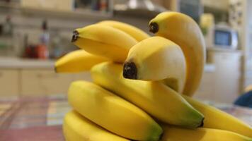 Closeup View Of Whole Juicy Bananas Bunches At Kitchen Stock Photo