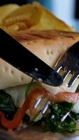 sandwich cut a piece with a fork and knife video