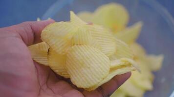 Crunchy potato chips being enjoyed in a casual setting video
