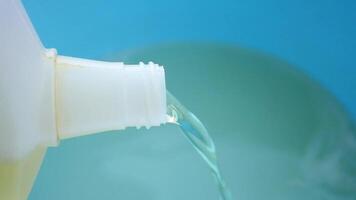 floor cleaning Liquid pouring from container into bowl in clear view video
