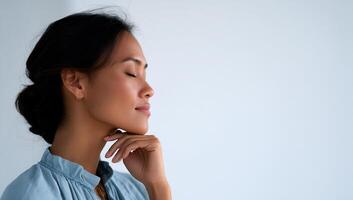 A woman is looking up with her hand on her chin photo