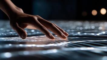 A person touching a surface with a glowing light photo