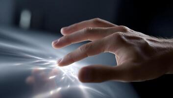 A person touching a light source with their hand photo