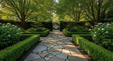 A stone path leads to a garden with hedges and trees photo