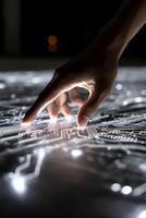 A person touching a circuit board with their finger photo
