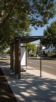 A bus stop with a bench and a tree photo