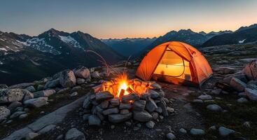 Campfire Sparks Illuminate Tent Against Mountain Backdrop at Dusk photo