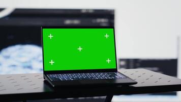 Surrounded by data and neural networks systems, laptop in empty space shows copy space screen for artificial intelligence automation and development. High tech data visualization. Camera A. video