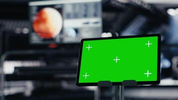 Close up of green screen tablet inside futuristic spacecraft bay used for monitoring system diagnostics. Chroma key device used for orbital navigation data in space station cockpit video