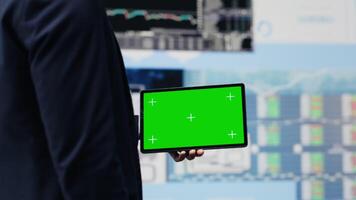 Young male boss holding tablet with copy space to explore new finance strategy with insight and reports in a digital workspace. Modern business intelligence and productivity. Camera A. video