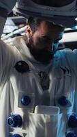 Vertical Astronauts in advanced technology spacecraft working together to update red planet updating flight log during routine mission check. Orbit station crew colleagues looking at system diagnostics video