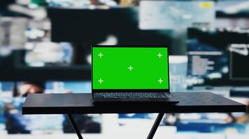 Mockup chroma key on a pc next to satellite imagery of enemy positions, high tech defense forces mission center used to gather intelligence for war planning. Secure global operations. Camera A. video
