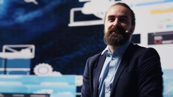 Male entrepreneur leading a visionary business pitch at the convention, inspiring the audience to fund important project. Businessman public speaker giving a speech for the crowd. Camera A. video