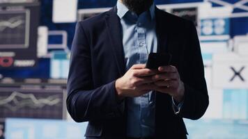 Business entrepreneur sending a text message with analytics reports, working hard on obtaining maximum performance for activity development success. Management and innovation. Camera A. video