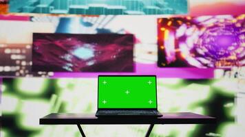 Laptop running isolated mockup screen surrounded by funky visual art clips, glowing in the dark and creating a clubbing atmosphere. Nightlife ambiance with modern beats and lights. Camera B. video