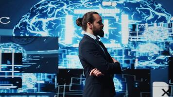 Male entrepreneur works on implementing AI brain system for deep learning, employing neural networks and cybernetics for growth. Using smart technology and algorithmic thinking. Camera B. video