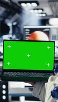 Vertical Cheerful astronaut doing videocall with Earth command center while aboard orbit station, sharing mission update. Happy cosmonaut talks with ground center team during communication link, camera B video