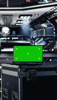 Vertical Green screen laptop inside futuristic spacecraft bay next to nearby monitor displaying Mars dashboard system telemetry. Mockup notebook used for navigation to red planet during orbital mission video