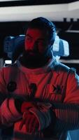 Vertical Portrait of smiling astronaut holding helmet inside space station, preparing for planetary mission outside. Happy starship crew member beginning landing procedures on solar system planet video