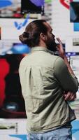 Vertical Young adult examines an user interface with multiple social media platforms and actions, content creator uses digitalization for visuals and entertainment. Networking multitasking. Camera A. video
