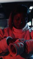 Vertical Astronaut conducting safety checks before stepping out for scheduled operations outside space station. Cosmonaut checks gear diagnostics on device, preparing to leave after landing on Mars, camera B video