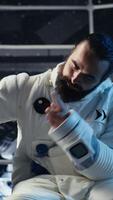 Vertical Starship cockpit glowing as cosmonaut watches unknown alien vessel approach from deep space. Man reacts to unidentified extraterrestrial presence hovering near orbital station, camera B video