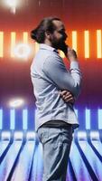 Vertical Trendy young person posing in neon lit futuristic environment, capturing the essence of youth culture, creativity and minimalism with a retro digital twist and strong street wear influence. Camera B. video