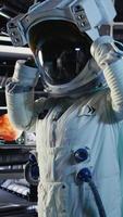 Vertical Portrait of happy astronaut holding helmet inside space station after completing surface mission on unfamiliar planet. Cheerful cosmonaut preparing for return to Earth, camera A video