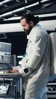 Vertical Astronaut using laptop to verify mission parameters after completing planet surface expedition. Cosmonaut manages systems using notebook, leaving Mars, updating flight log to return home, camera B video