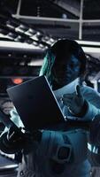 Vertical Happy female cosmonaut doing videocall with family using smartphone during galaxy expedition. Africna american woman doing remote call with loved ones using mobile phone in spaceship, camera A video
