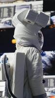 Vertical Curious astronaut standing on a distant planet in space suit and helmet, collecting samples beneath the sky filled with stars. Exploring alien worlds and cosmic frontiers in a space craft. Camera A. video