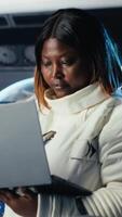 Vertical Close up of cosmonaut studying mission plans on device before expedition, preparing for future of mankind. Astronaut in spaceship explores planet to support human life beyond Earth video