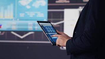 Modern businessman uses digital graphs and analytics to improve finance models for fruitful management decisions. Optimizing performance with tech intelligence and insightfulness. Camera A. video